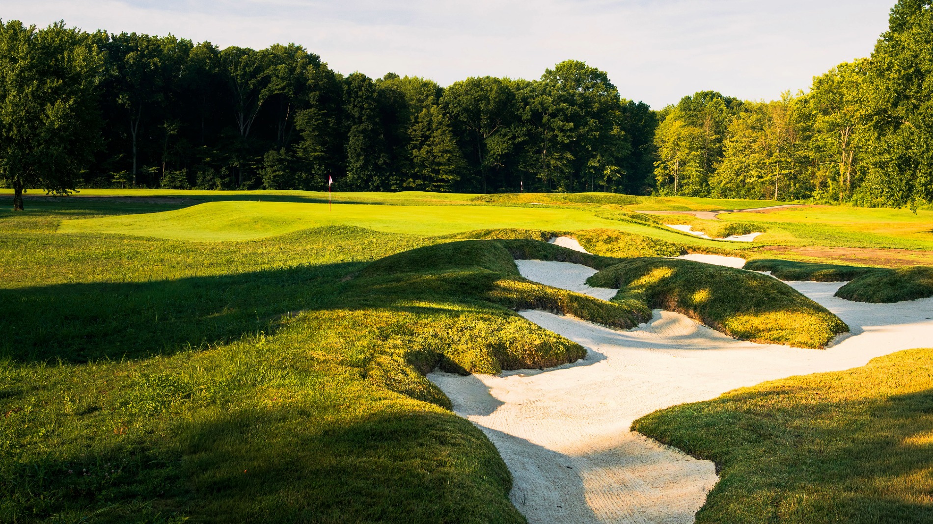 The sixteenth features a string of bunkers, a wide fairway and a green that runs subtly away from shots played from the right (Photo: Evan Radzanowski Photography)